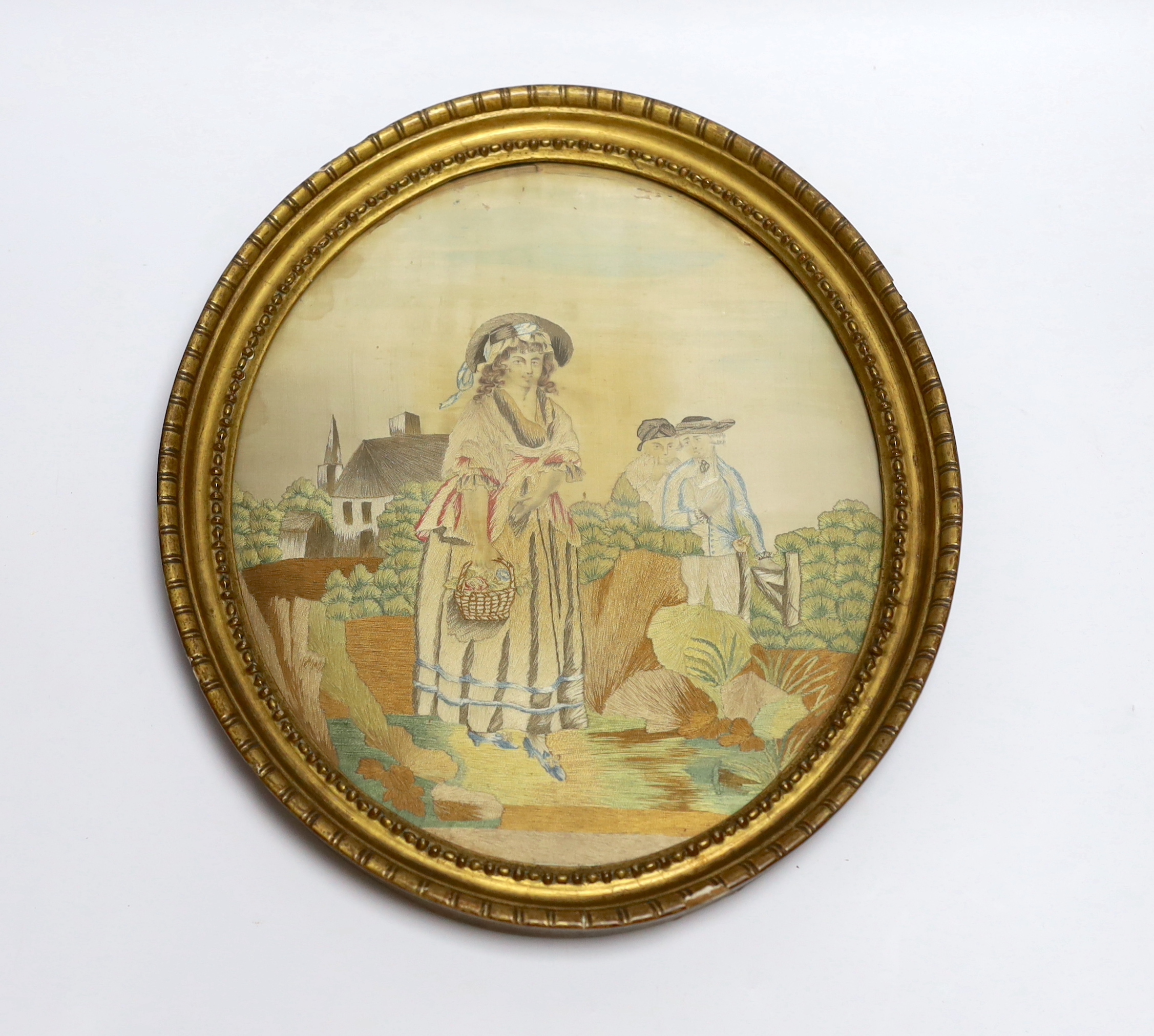 An oval framed regency needlework on silk, 